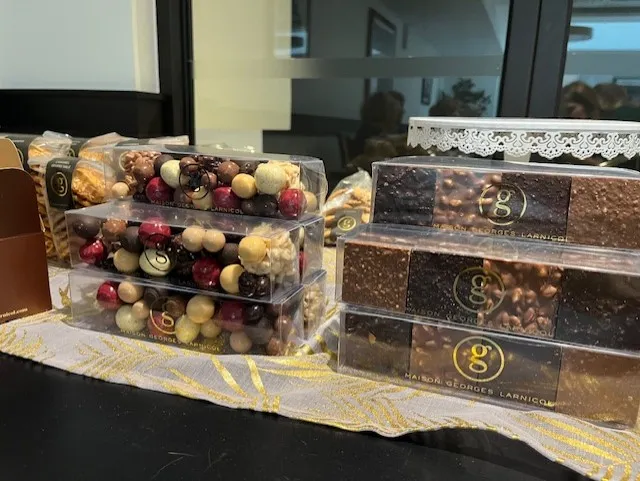 Trays of Larnicol chocolates and sweets laid out on a lace-covered table