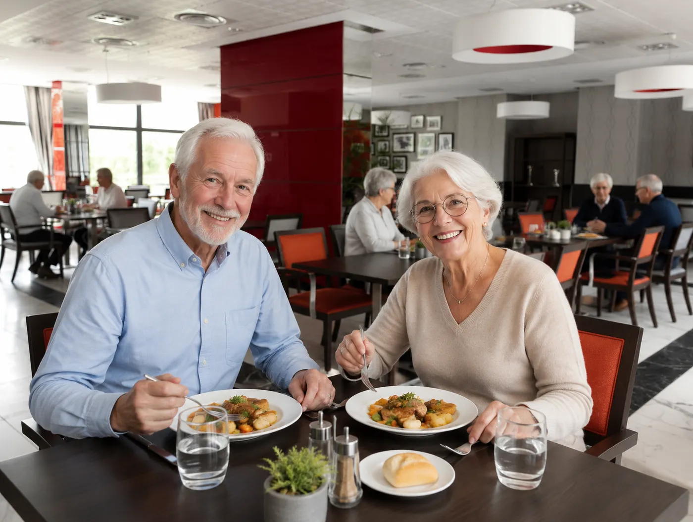 A senior couple enjoying their plates at a table in the residence restaurant