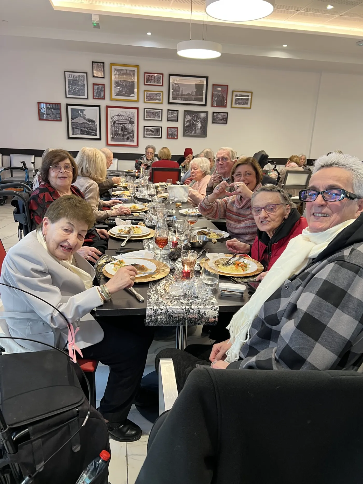 Residents raising their glasses around the table at the New Year lunch