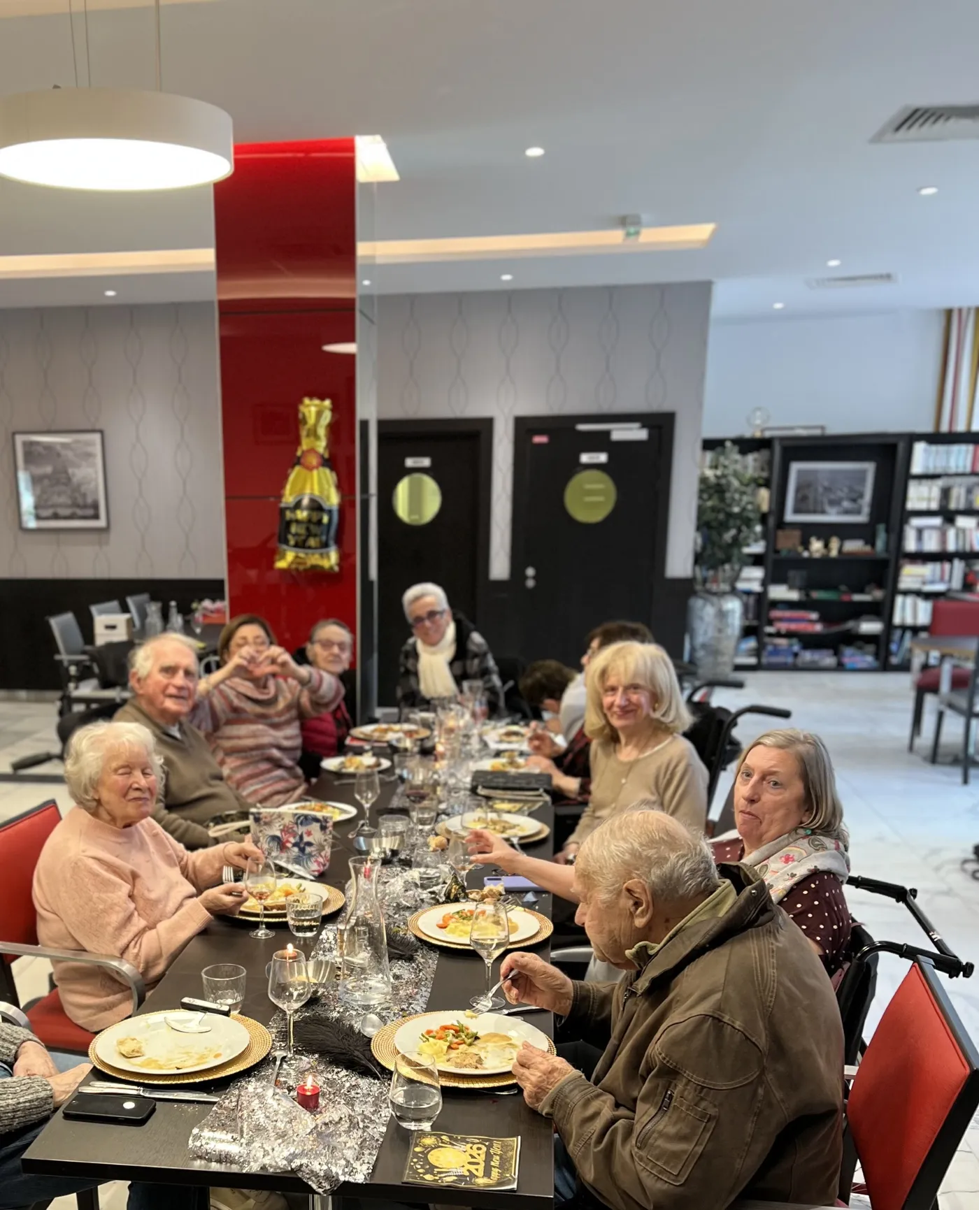 A long table of residents enjoying their New Year meal in the restaurant