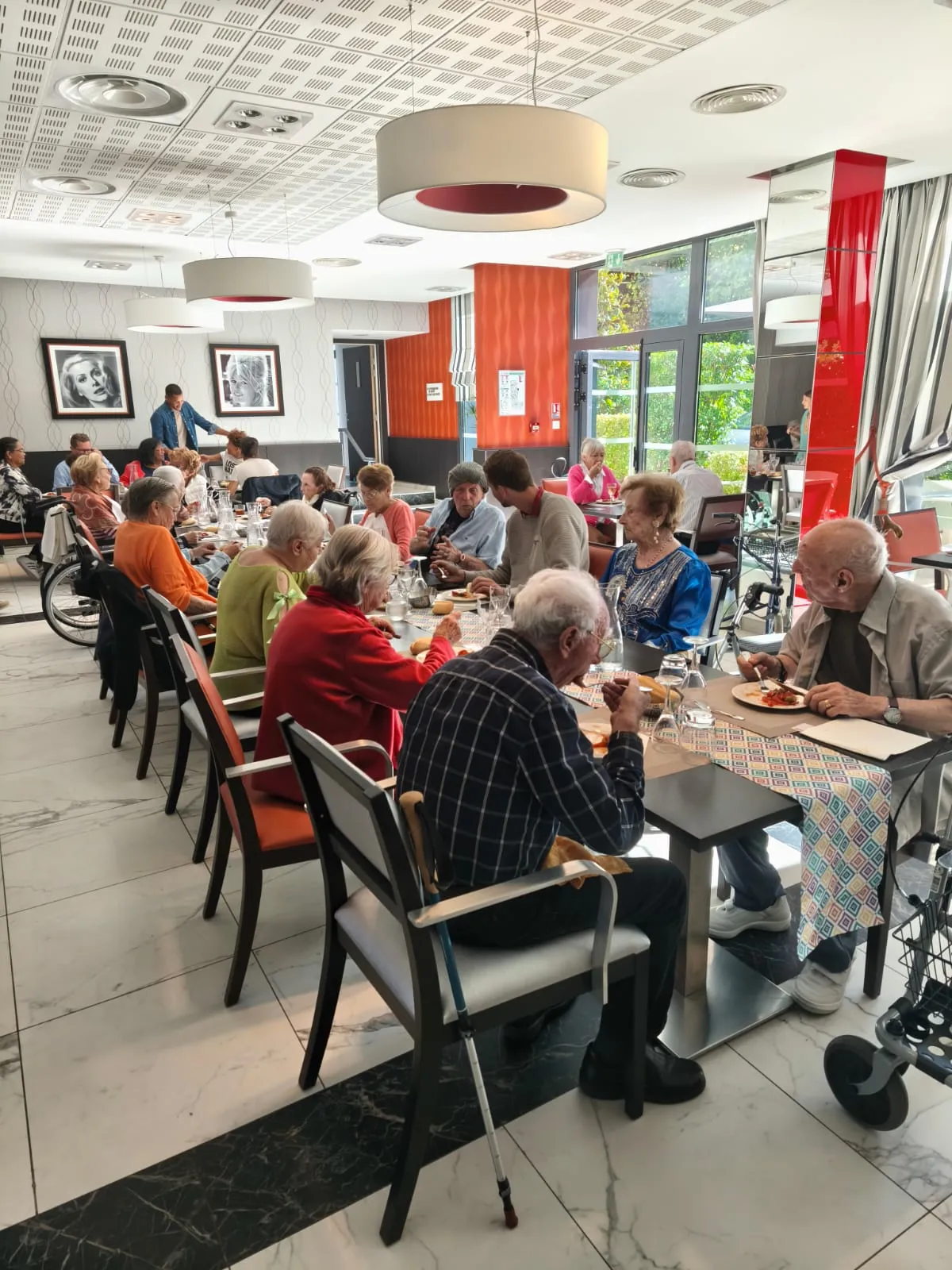 The Le Cannet dining room filled with residents at the long tables