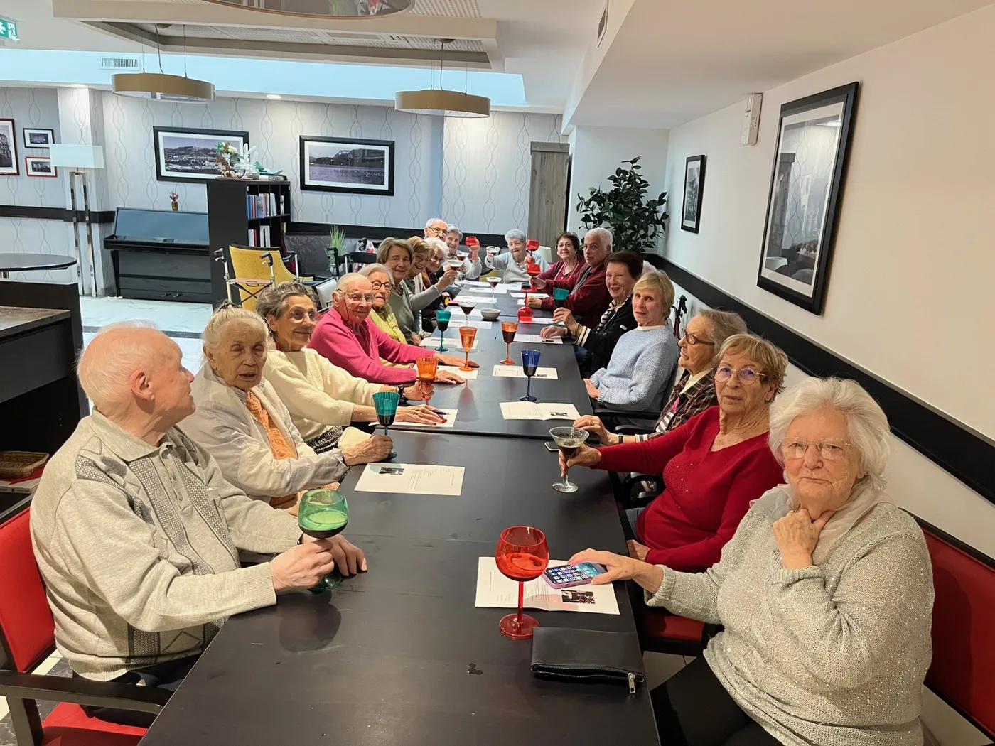 Residents seated along the table with their coloured cocktails