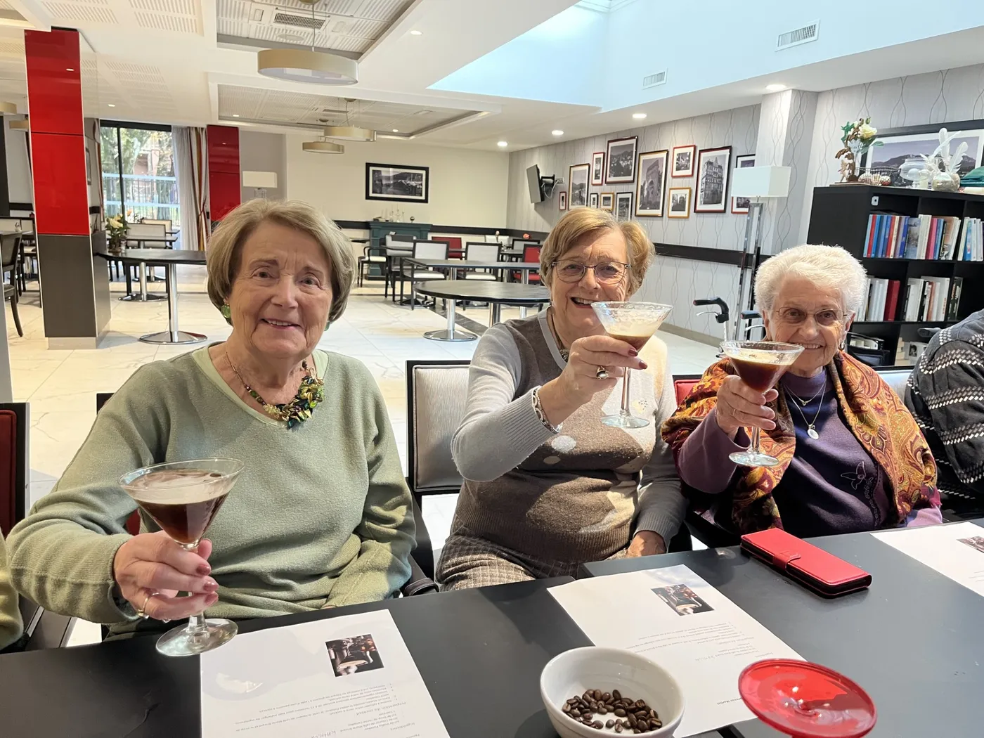 Three residents raising their cocktail glasses to the camera