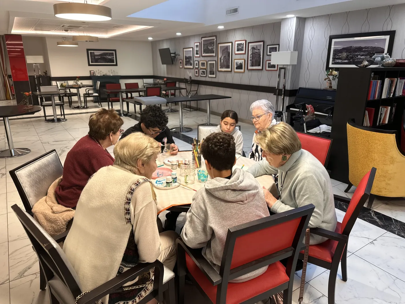 Residents and children working side by side at the craft table