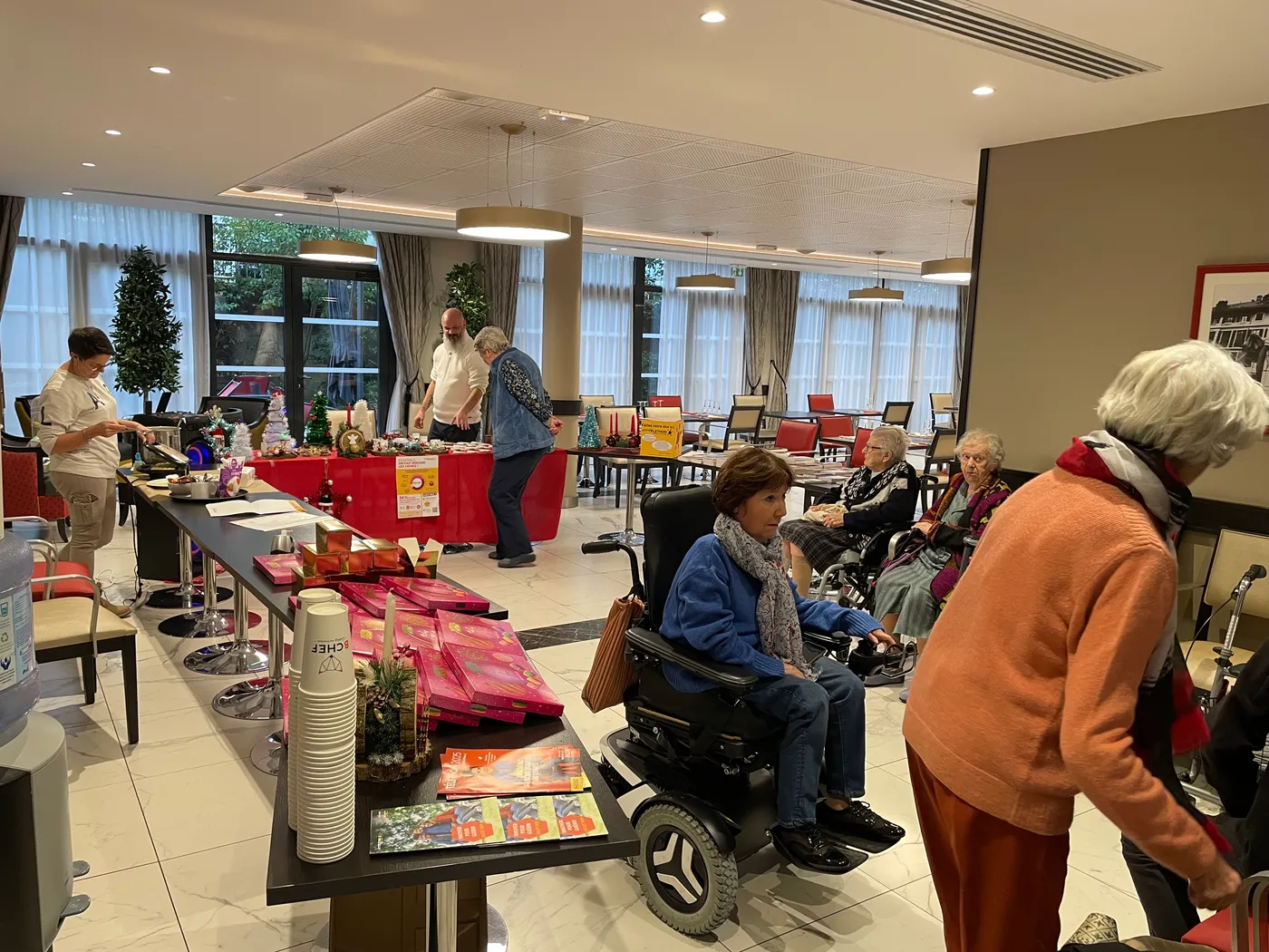 Residents in the lounge browsing the Telethon sale tables