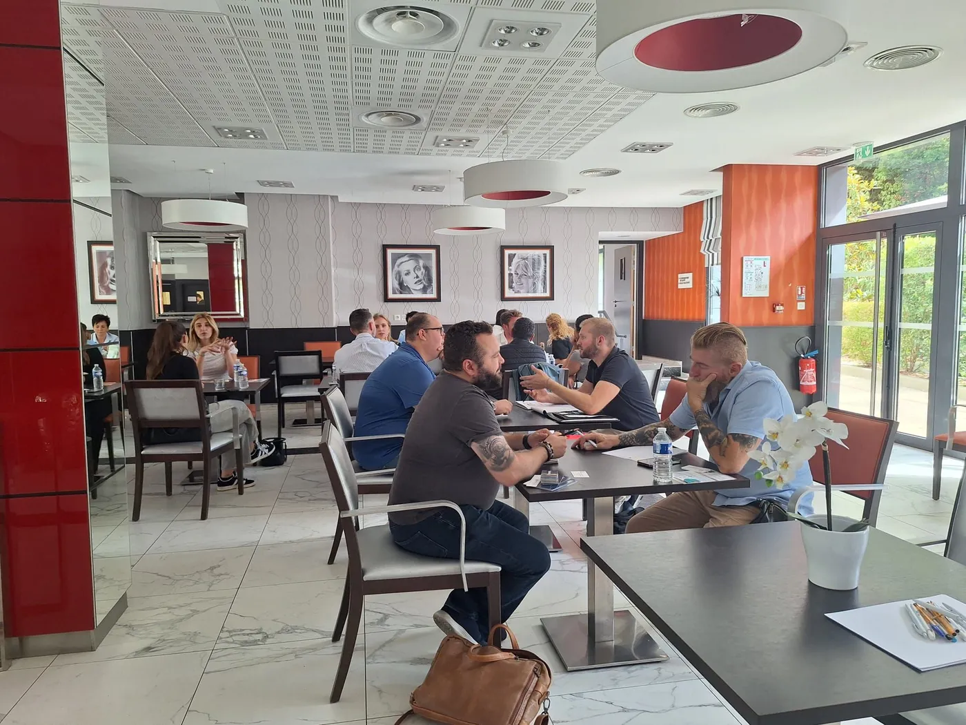 Participants seated in twos and threes at the tables during the networking session