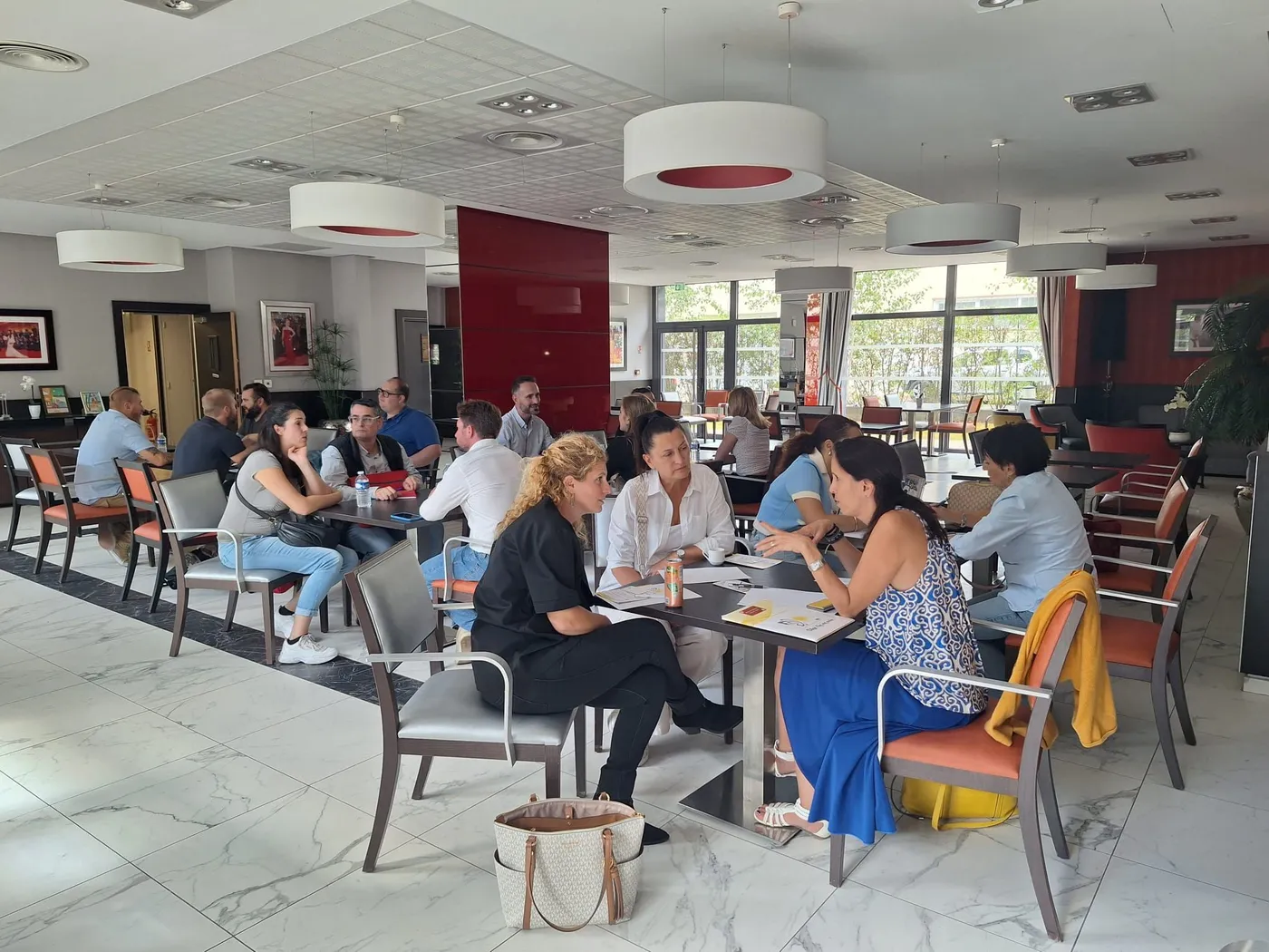 Professionals in discussion at the tables of the residence restaurant